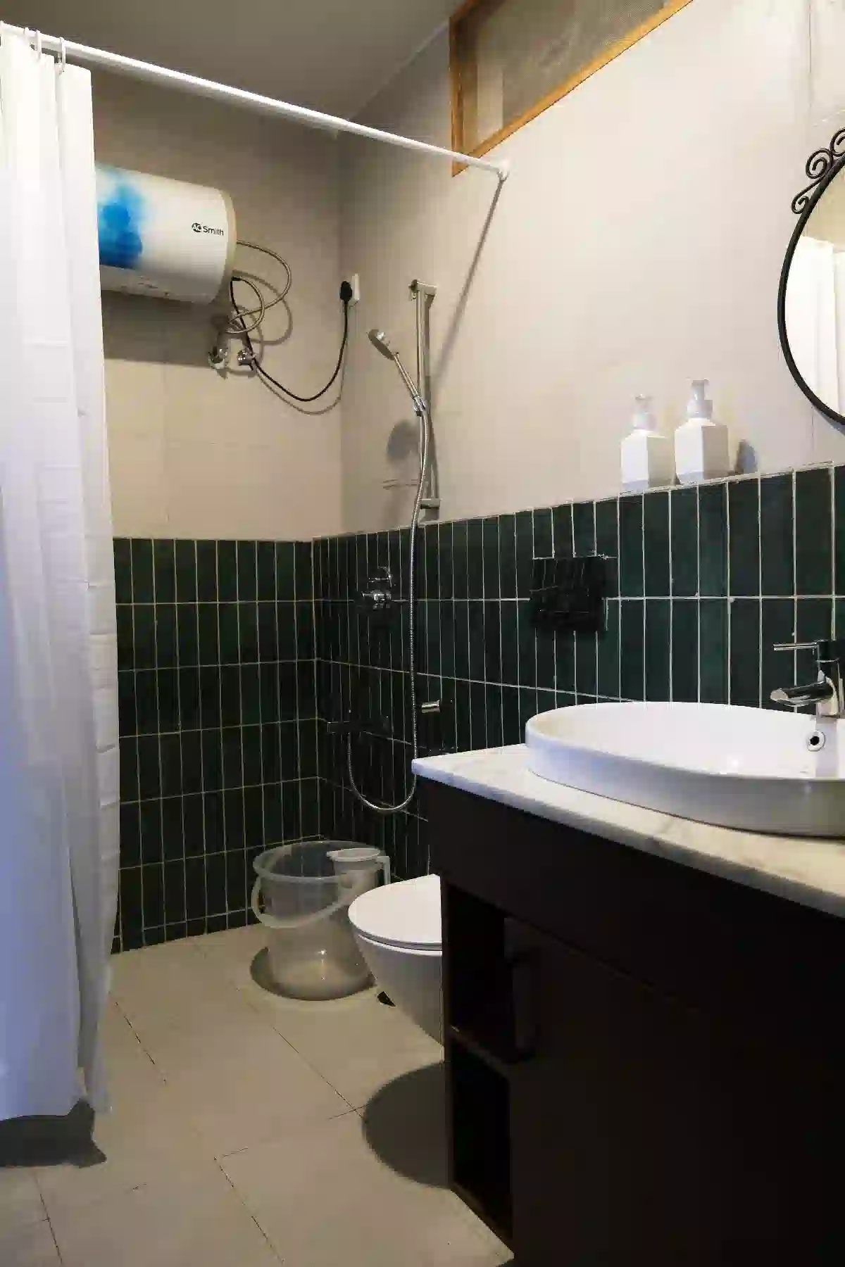 Clean attached bathroom with shower and modern fittings at Cardamom Pods, Kodaikanal