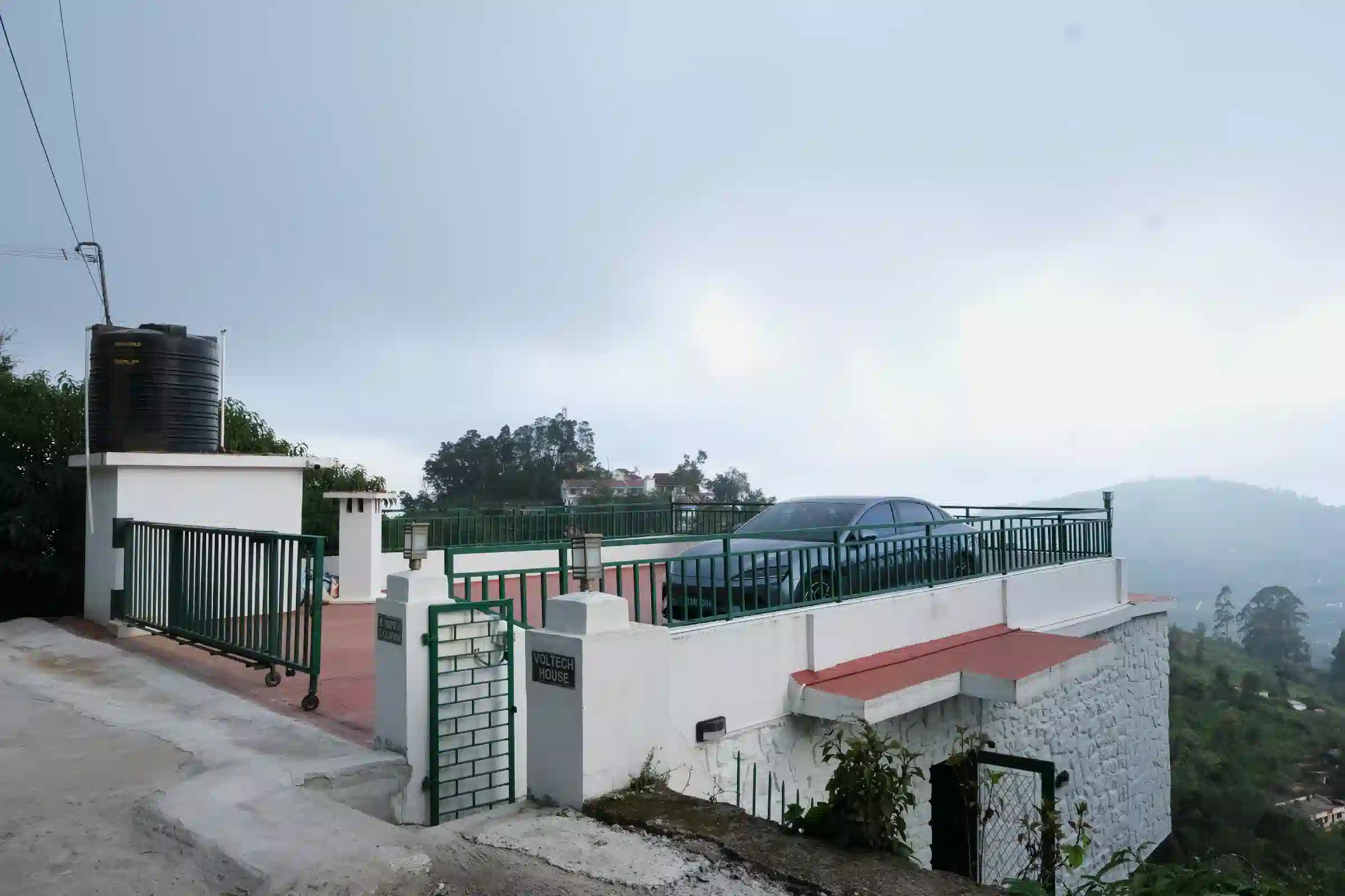 Cardamom Pods resort exterior with parking and hill views in Kodaikanal