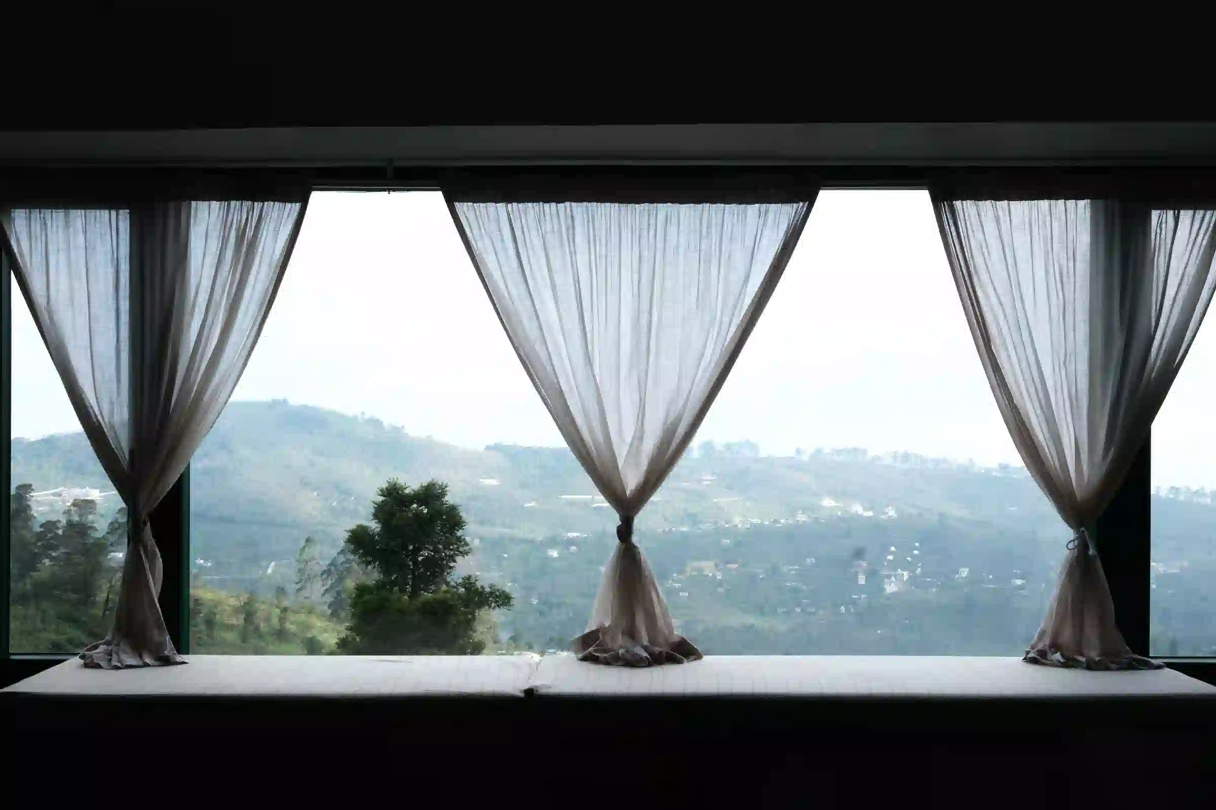 Scenic window view overlooking misty hills in Kodaikanal at Cardamom Pods
